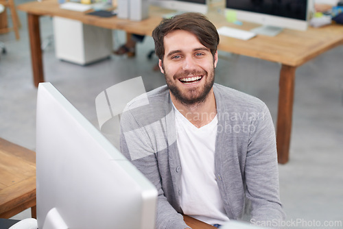 Image of Man, portrait and journalist on computer for research in office, planning and information for article. Happy male person, online and connection for website, laughing and humor for project or news