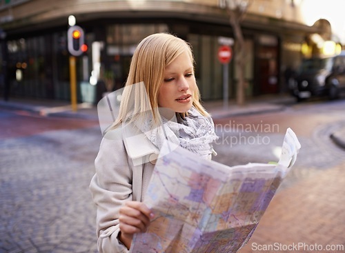 Image of Woman, tourist and reading a map in city street for directions, travel or journey in Cape Town. German female, confused and holding a navigation chart in urban background on vacation, holiday or lost