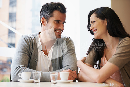 Image of Love, talking and couple with coffee on date for romance or anniversary in cafeteria. Happy, bonding and young man and woman in conversation drinking latte, espresso or cappuccino at restaurant.