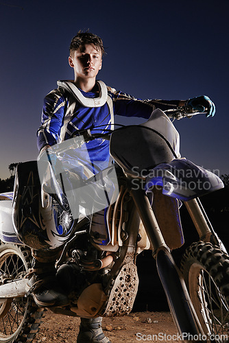 Image of Sport, competition and portrait of man with off road motorbike, confidence and gear for race challenge. Adventure, adrenaline and serious face of athlete on extreme course with dirt bike in evening