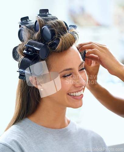 Image of Woman, face and hands with hair curlers for beauty, haircare and hairstyle with makeup or cosmetics at hairdresser. Person, happy and roller set for grooming, curling and getting ready with skincare