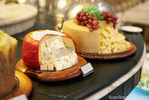 Image of Food, cheese and fruit in restaurant display for catering service, buffet selection and banquet for eating. Cafeteria, fine dining and closeup of table for lunch, supper and dinner event for wellness