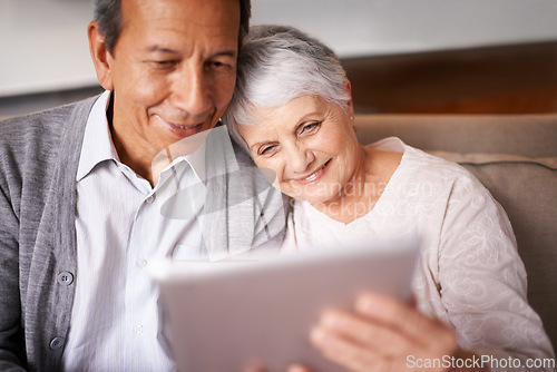 Image of Senior, couple and hug with tablet on sofa for online bingo, crossword puzzle or internet games with smile. Elderly, man and woman with face, happiness or embrace with technology for web news in home