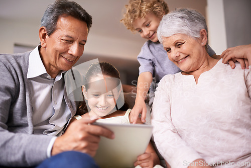 Image of Happy family, grandparents and kids with tablet for social media, entertainment or research on sofa at home. Grandma, grandpa and young children smile on technology for online show or movie at house