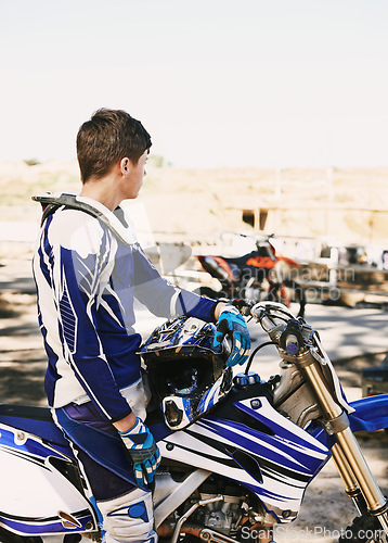Image of Motorcycle, extreme sport and man for race on trail for competition, vision or games with speed. Racer, motorbike and thinking for contest, motor cross and fast transportation with sunshine in desert