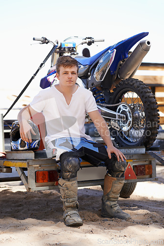 Image of Man, motorcycle and portrait with pickup truck, sport and trailer with pride for contest, ready and motor cross. Person, feet and boots for race, game and dirt bike on trail, path or countryside road