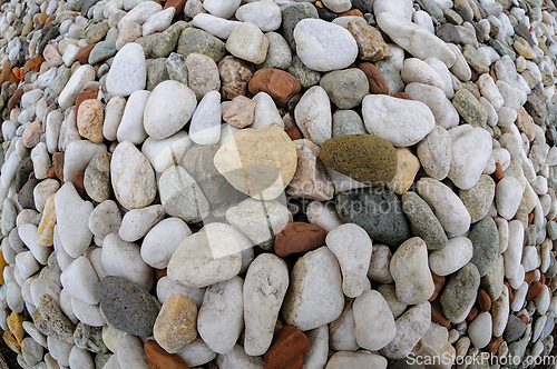 Image of Multicolored pebbles arranged in an intricate circular pattern o