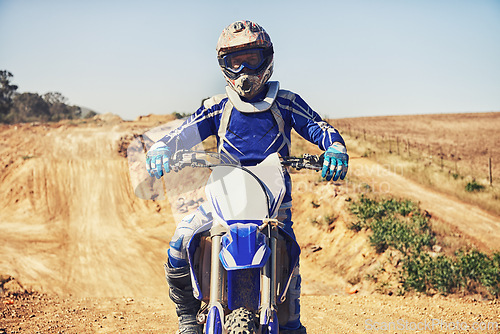 Image of Person, portrait and motorcyclist on dirt bike for extreme sports, outdoor competition or race. Expert or professional rider on motorbike or scrambler on sand course for challenge or off road rally