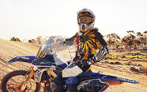 Image of Helmet, race and man on dirt bike in desert with adventure, adrenaline or speed in competition, Extreme sport, trick and athlete on off road motorcycle for challenge, power or danger on action course