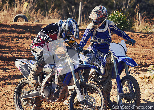 Image of Sport, teamwork or racer on motorcycle outdoor on dirt road with support in driving, challenge or competition. Motocross, motorbike or dirtbike driver and helmet on offroad course or path for racing