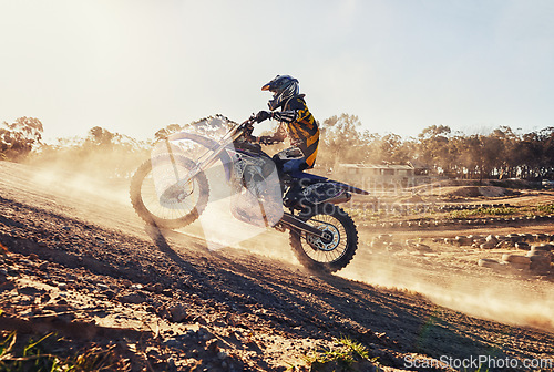 Image of Hill, race and man on dirt bike in desert with adventure, adrenaline and speed in competition, Extreme sport, dust and athlete on off road motorcycle for challenge, power or danger on action course