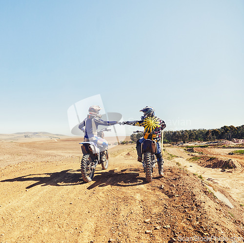 Image of Sport, teamwork or people on motorcycle outdoor on dirt road before racing, challenge or competition on mockup. Motocross, dirtbike driver and fist bump with helmet on offroad course for performance