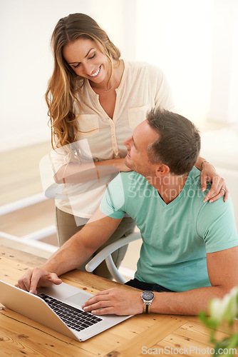 Image of Happy couple, laptop and love in home in morning and relax on social media for bonding together. Man, woman and smile in modern apartment for romantic holiday, care and technology for online shopping