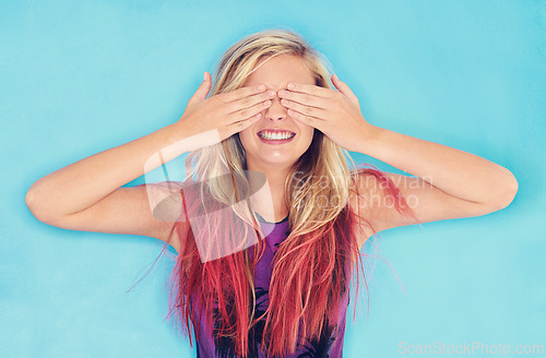 Image of Smile, woman or hide face in studio for surprise or excited for secret announcement by blue background. Female, student and peek a boo for scholarship or competition and education in review or mockup