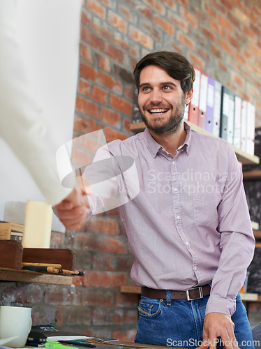 Image of Man, office and handshake to greet with smile in interview for career, welcome and happy. Male person, satisfied and agreement with deal at work for project, collaboration and meeting for job.