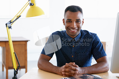 Image of Young businessman, portrait and confident in office by desk, consultant and creative in fashion. Happy, black man or positive face of designer in co working space or about us for ambition in company