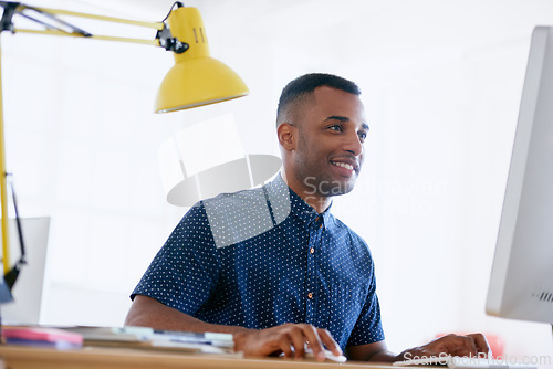 Image of Businessman, happy or working in office on desktop, planning or ambition with productivity in career. Journalist, smile and typing on computer for networking and online research for creativity in job