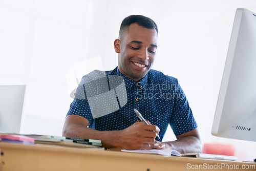 Image of Computer, research and man writing notes in office for creative project on internet by desk. Technology, smile and professional male designer working online with desktop in modern workplace.