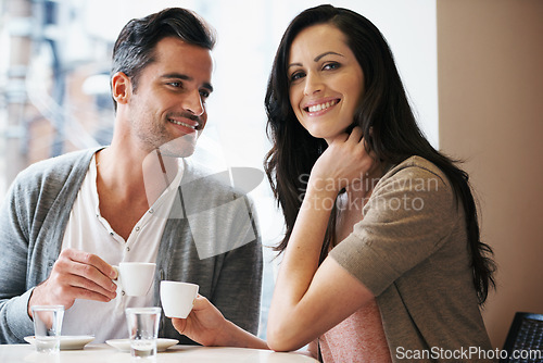 Image of Love, portrait and couple with coffee on date for romance or anniversary in cafeteria. Happy, bonding and young man and woman talking and drinking latte, espresso or cappuccino at restaurant.