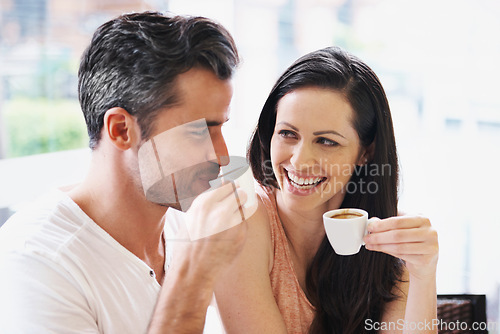 Image of Happy, discussion and couple with coffee on date for romance or anniversary in cafeteria. Love, bonding and young man and woman talking and drinking latte, espresso or cappuccino at restaurant.