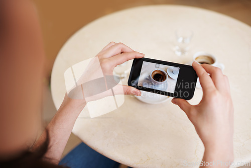 Image of Hands, smartphone screen and top view photography of coffee, tea or espresso for social media, content or blogging. Closeup, person and cellphone with hot beverage cup at restaurant, cafe and table