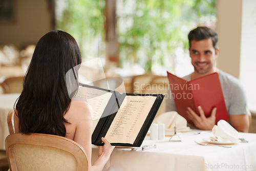 Image of Couple, restaurant and menu for food choice, fine dining and bonding on valentines day. People, love and romance at cafe or lunch selection for anniversary date, gourmet cuisine and happy at bistro