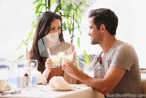 Image of Couple, restaurant and toasting for anniversary celebration, fine dining and bonding at bistro. People, love and romance at cafe or cheers with alcohol or cocktail, marriage milestone and happy