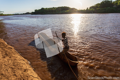 Image of Ferryman on wooden coarse boat on mystical Omo river, Ethiopia