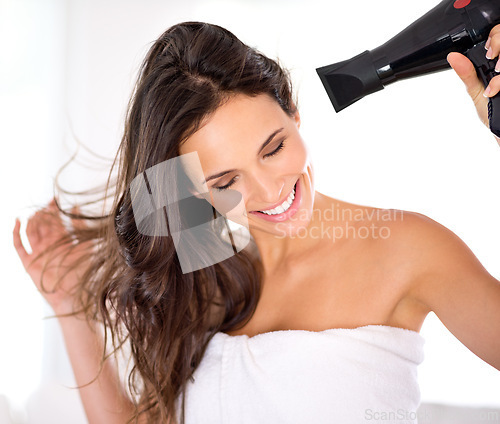 Image of Hair, woman and happy with hairdryer in bathroom, morning routine for grooming and beauty at home. Cosmetology, transformation with electric appliance for blow drying and haircare, texture and growth