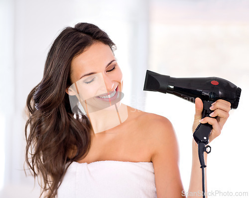 Image of Hair, woman with smile and hairdryer in bathroom, morning routine for grooming and beauty at home. Cosmetology, transformation with electric appliance for blow drying and haircare, texture and growth