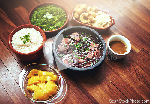 Image of Black beans, vegetables and Mexican food on table with Mediterranean cooking, vegan and nutrition for diet. Health, green and dish at restaurant or diner with organic, salad and appetizer for dinner