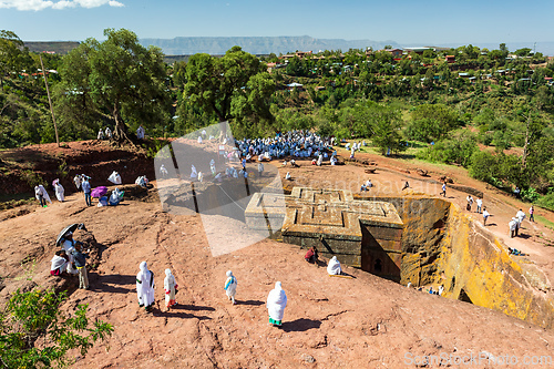 Image of Orthodox christian Ethiopian people behind famous rock-hewn church, Lalibela Ethiopia people diversity,