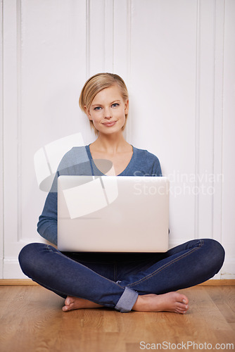 Image of Laptop, smile and portrait of woman on floor working on freelance project for remote job. Happy, technology and young female person sitting on ground with computer for online research at home.