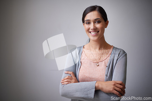 Image of Space, designer or portrait of happy woman in studio with arms crossed, business or confidence. Creative, employee or proud entrepreneur with startup, project or mockup isolated on grey background