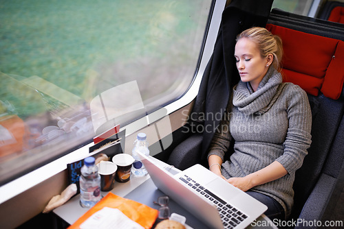 Image of Woman, train and sleep with travel or laptop or relax commute or journey tired, window or transportation. Female person, railroad and seat resting in Canada as passenger for comfort, internet or trip