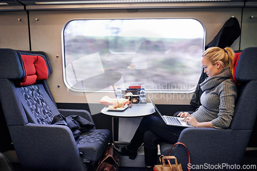 Image of Woman, train and travel with laptop on journey or research project on commute for destination, transportation or internet. Female person, railroad and passenger in Canada for comfort, tourist or trip