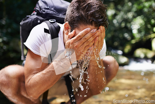 Image of Water, splash or man hiking in forest or wilderness for cleaning face or trekking adventure. River, relax or male hiker on break walking in a natural park or nature for exercise or wellness by a lake