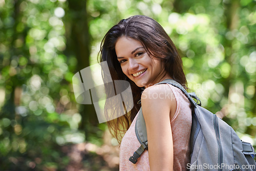 Image of Hiking, woods or portrait of happy woman in forest or wilderness for a trekking adventure. Smile, bag or excited female hiker walking in a natural park or nature for exercise or wellness on holiday