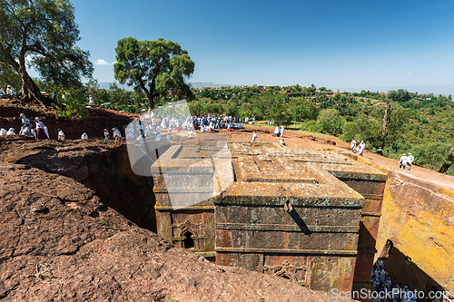 Image of Orthodox christian Ethiopian people behind famous rock-hewn church, Lalibela Ethiopia people diversity,