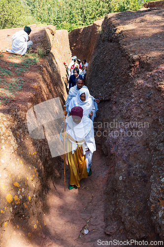 Image of Orthodox christian Ethiopian people behind famous rock-hewn church, Lalibela Ethiopia people diversity,