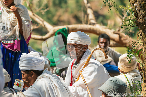 Image of Orthodox christian Ethiopian people behind famous rock-hewn church, Lalibela Ethiopia people diversity,
