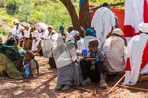 Image of Orthodox christian Ethiopian people behind famous rock-hewn church, Lalibela Ethiopia people diversity,