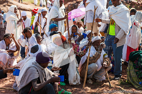 Image of Orthodox christian Ethiopian people behind famous rock-hewn church, Lalibela Ethiopia people diversity,