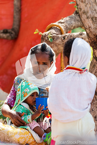 Image of Orthodox christian Ethiopian people behind famous rock-hewn church, Lalibela Ethiopia people diversity,