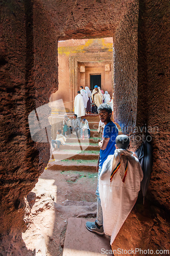 Image of Orthodox christian Ethiopian people behind famous rock-hewn church, Lalibela Ethiopia people diversity,