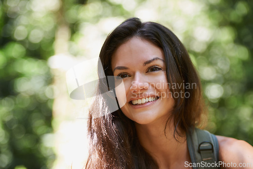 Image of Hiking, face or happy woman with smile in forest or wilderness for a trekking adventure. Woods, travel or excited female hiker walking in a natural park or nature for exercise or wellness on holiday