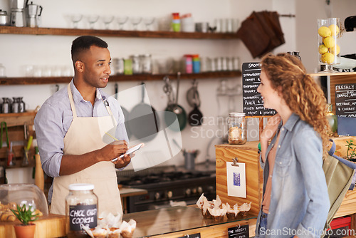 Image of Woman, cafe and barista with order at counter for purchase, shopping and lunch at coffee shop. Female person, small business and waiter with notepad for discussion, writing and customer service