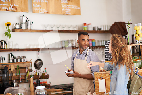 Image of Customer, coffee shop and barista with writing at counter for order, purchase and breakfast at cafe. Female person, small business and waiter with notepad for discussion, help and food service