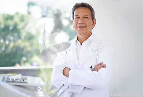 Image of Portrait, dentist and man in clinic with confidence in expert advice, orthodontics and medical health. Dental medicine, healthcare and professional with pride, arms crossed and trust in oral service.