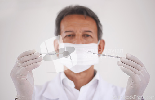Image of Portrait, dentist and man with tools, mask and expert advice for orthodontics in medical health. Dental medicine, healthcare and professional with pride, steel equipment and ppe for oral service.